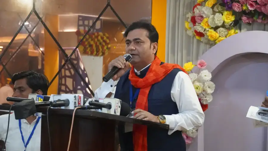 A speaker addresses the hall at Hotel Royal Park, Indirapuram