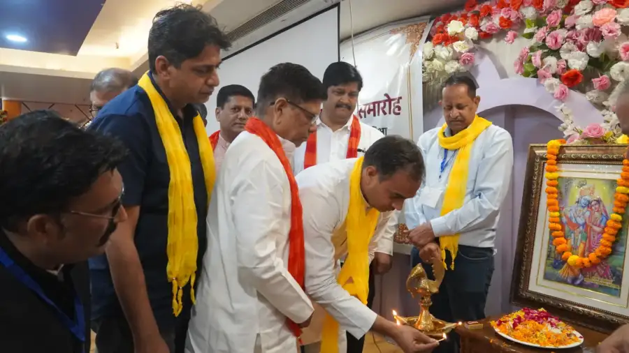 Guests light the lamp before a garlanded portrait